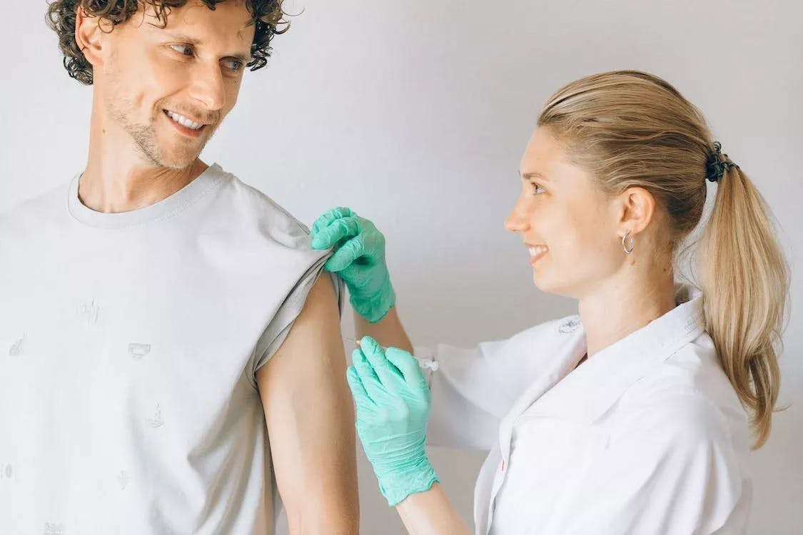 doctor giving patient an injection in the arm